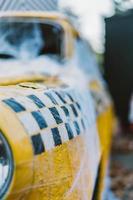 Old retro yellow taxi decorated with cobwebs photo