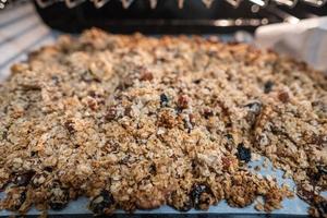 granola to cook in an electric oven. concept of simple ingredients for healthy breakfast photo