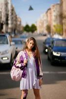 Young beautiful woman on the background of cars photo
