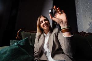 Woman in business suit holding crystal ball photo