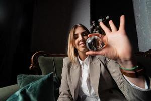 Woman in business suit holding crystal ball photo