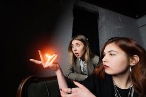 Woman and woman fortune teller with crystal ball photo