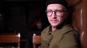 Unhappy single man drinking beer at bar or pub photo