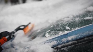 Woman removing snow from car photo