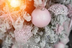 Different object toy gifts hanging on a decorated Christmas tree. photo