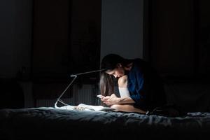 Side view woman working in dark bedroom. photo