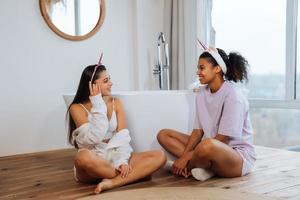 Two girls talking on the bathroom floor photo