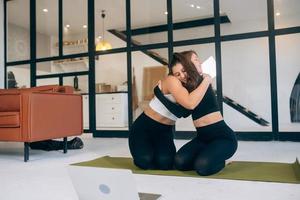 Two girlfriends hug each other after yoga photo