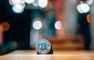 Silver bitcoin isolated on the table, glowing background photo