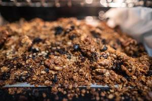 granola to cook in an electric oven. concept of simple ingredients for healthy breakfast photo