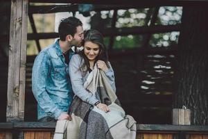 Young couple wrapped in plaid photo