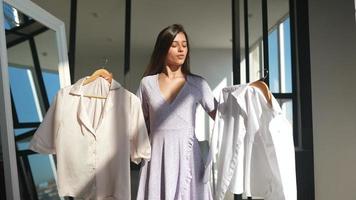 Beautiful girl trying dress in room photo