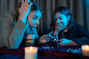 Woman and woman fortune teller with crystal ball photo