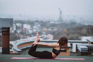 mujer practicando yoga en la alfombra del techo y haciendo ejercicios de yoga foto