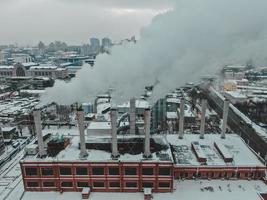 Large central boiler room with giant pipes of which there is dangerous smoke in winter during frost in a big city photo
