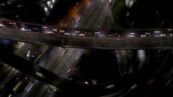 Aerial view of highway interchange at night, timelapse. photo