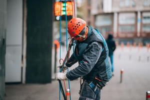 Worker climber preparing for work at height. photo