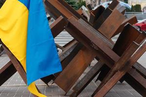 The Ukrainian flag hangs on barricades in the city photo