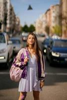 Young beautiful woman on the background of cars photo