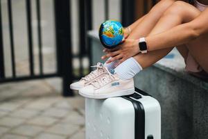 Cropped photo. Beautiful young woman holds a small globe photo