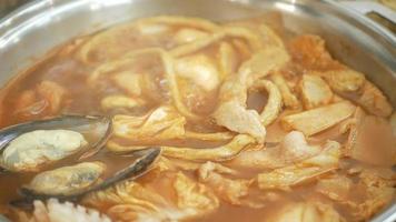 close up while using chopstick pick pork slice from Korean Kimchi soup video