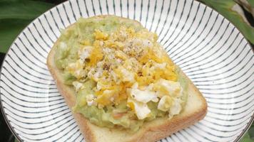 plate of avocado toast with fried scrambled egg. Healthy meal dish video