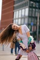 Portrait of pretty young woman, having fun at the street. photo