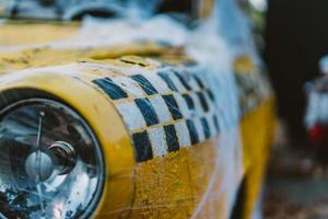 Old retro yellow taxi decorated with cobwebs photo