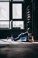 Portrait of attractive young woman doing yoga or pilates exercise photo