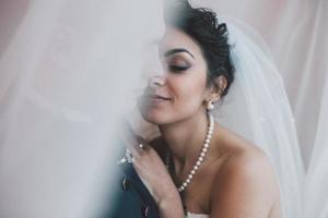 Bride and groom in a hotel room photo