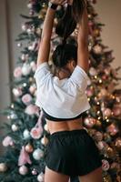 Girl posing against the backdrop of Christmas decor. photo