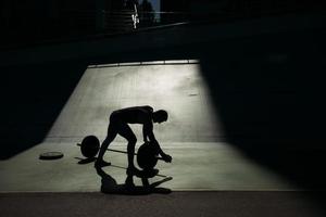 Handsome bodybuilder guy prepare to do exercises with barbell photo