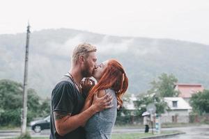 beautiful couple hugging in the rain photo