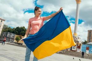 Young woman with national flag of Ukraine on the street photo