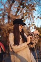 Beautiful young girl with handbag posing on camera photo