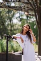 Young beautiful woman teasing and showing tongue at camera in park photo