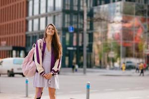 Playful portrait of pretty young woman, having fun at the street. photo