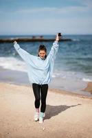 Beautiful woman in a public beach after walk with sporty look photo