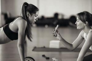 Young woman practicing yoga, is engaged with the teacher online. photo