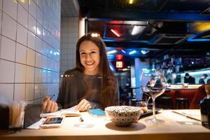 Woman works at a cafe in the evening photo