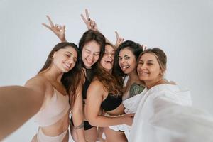 Diverse models wearing comfortable underwear take selfie photo