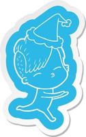 cartoon  sticker of a girl in onesie wearing santa hat vector