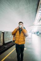 Guy standing at station in medical protective mask on his face. photo