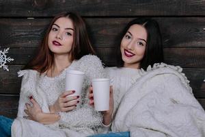 two girls drinking hot beverage photo