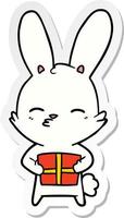 sticker of a curious bunny cartoon with present vector