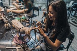 Portrait of young woman enjoying favorite job in workshop. photo