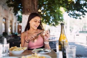 Close-up woman having breakfast cin street cafe outdoors photo