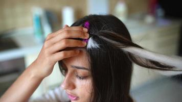 Process of braiding. Master weaves braids on head in a beauty salon, close up photo