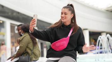 Woman using smartphone indoor. Texting and communicating in mall photo