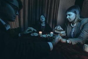 People hold hands of night at table with candles photo